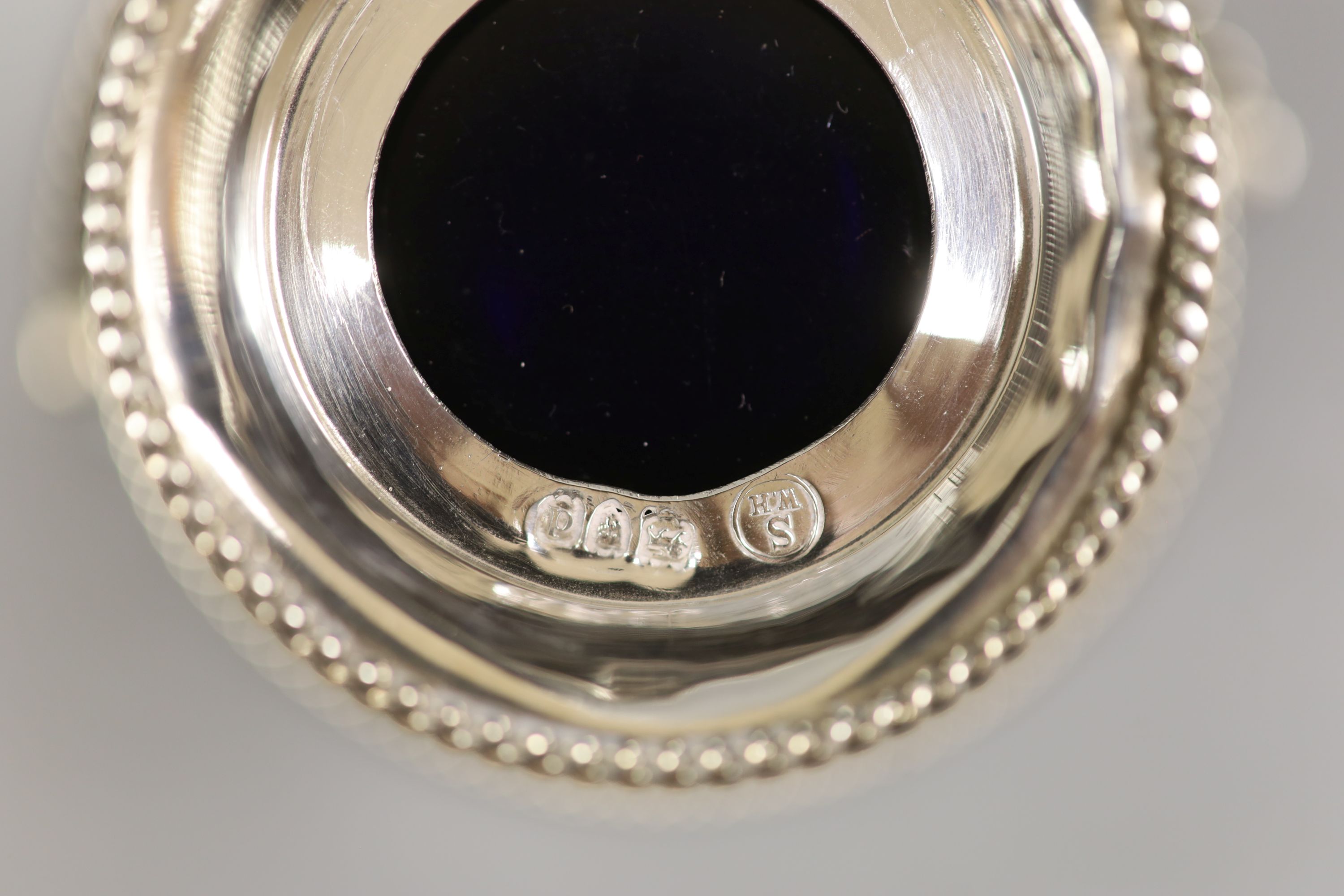 A late Victorian pierced pale-shaped small sugar basket, with cobalt glass liner, William Henry Skinner, London, 1899, height 67mm.